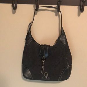 Black pocketbook with silver clasps and buckles